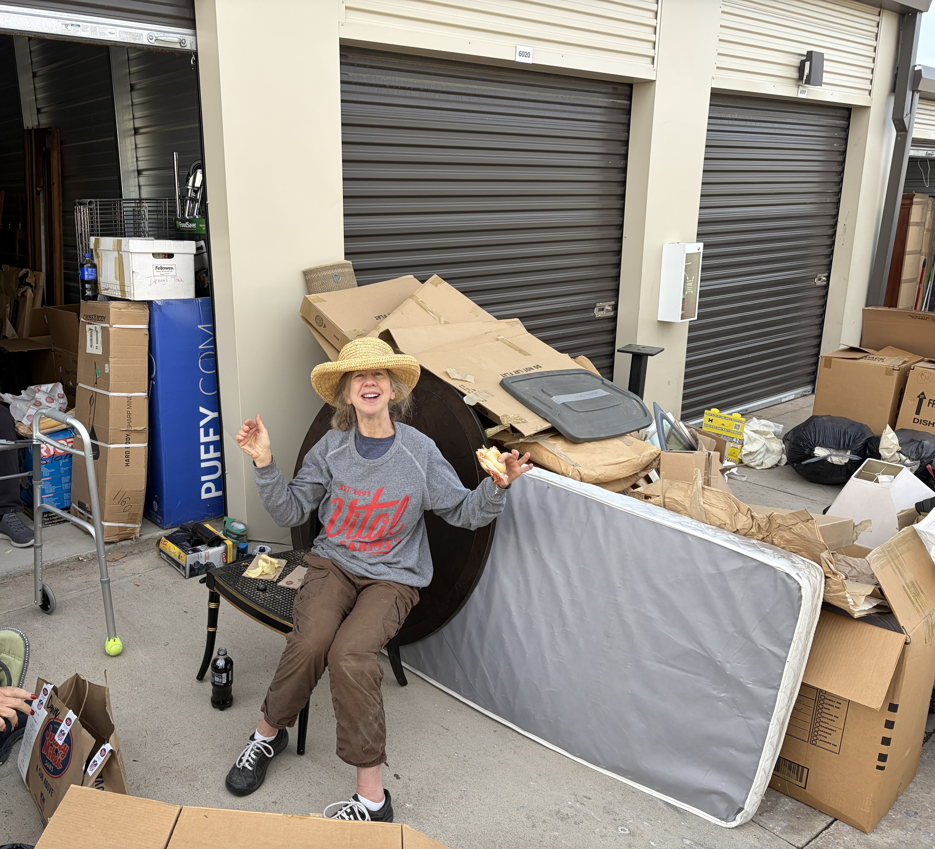 Woman posing in cluttered storage unit