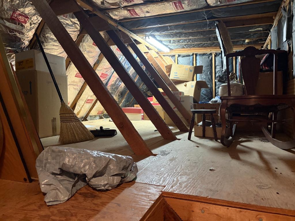 Attic before cleanout — cluttered with boxes and furniture