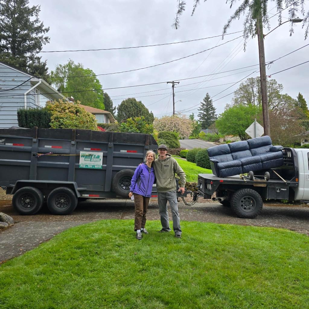 Mim with junk removal crew after a successful cleanout — two trucks loaded and ready to go