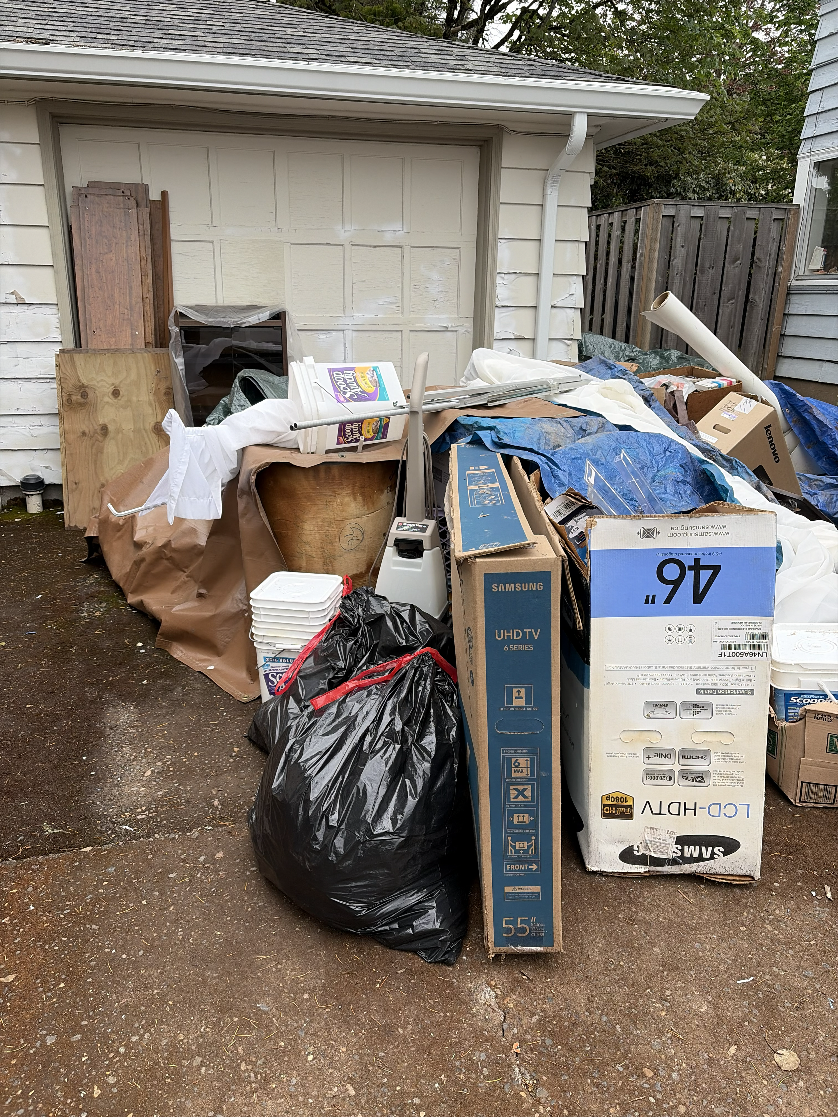 Driveway piled with junk before cleanout